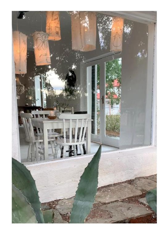 a porch with a white table and chairs and windows at The Richmond Café and Rooms in Richmond