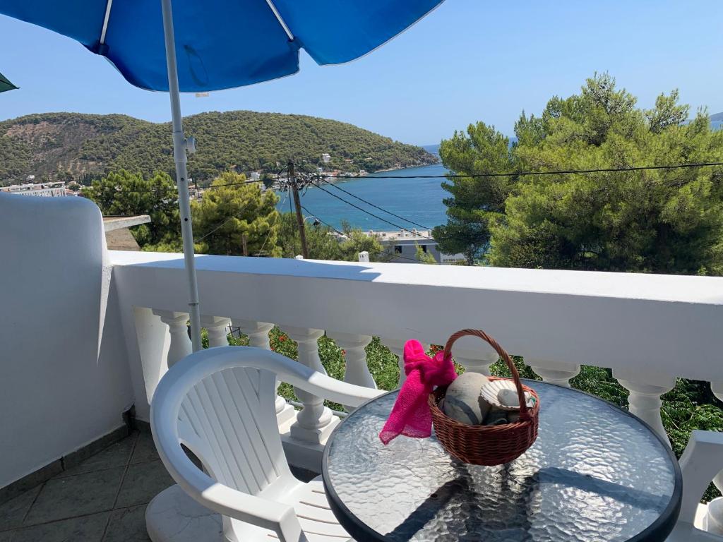 a basket sitting on a glass table on a balcony at Apartment Villa Loula in Poros
