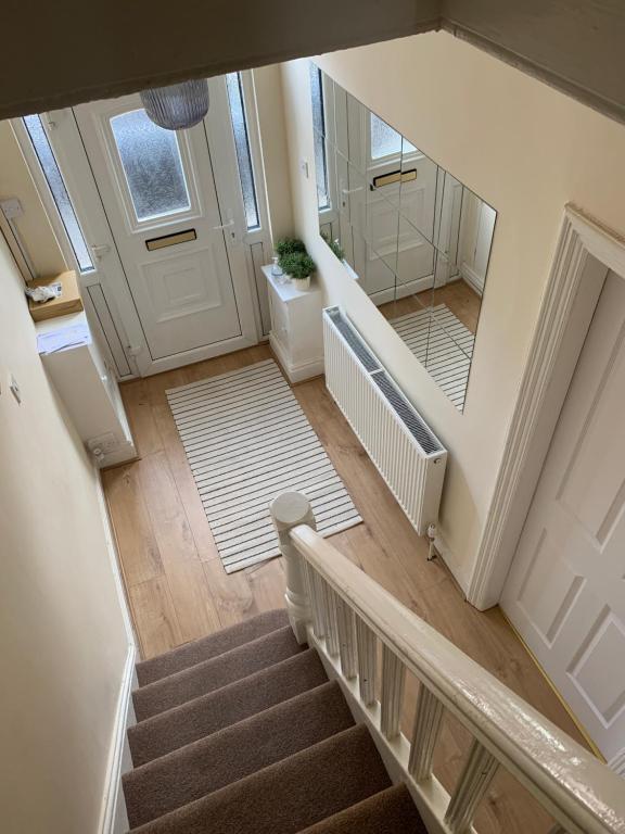 an overhead view of a stairway with a white door and a stair case at Large House Near Anfield & Liverpool Town in Liverpool