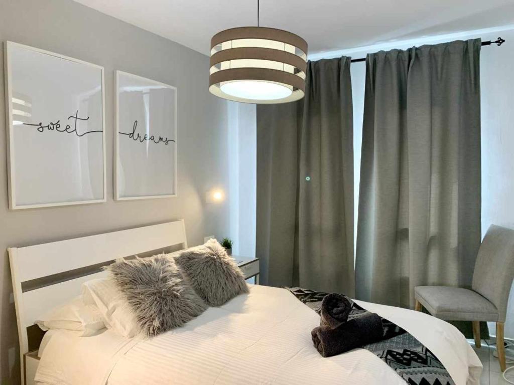 a bedroom with a bed with a dog laying on it at Holyhome apartment 208 in Costa Teguise