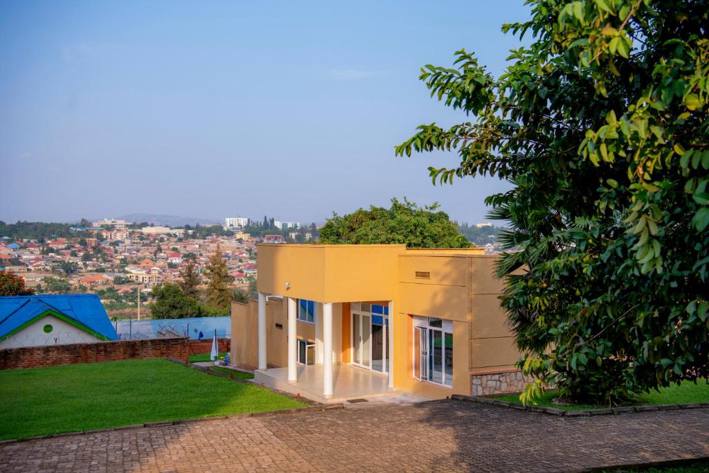 a yellow house with a view of a city at Fleur Guest House in Kigali