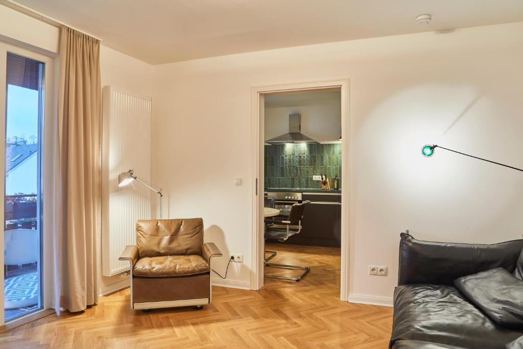 a living room with a couch and a chair at Gemütliche Wohnung mit Balkon in Deidesheim