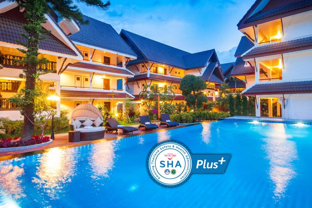
a swimming pool with a large blue and white swimming pool at Nak Nakara Hotel-SHA Extra Plus in Chiang Rai
