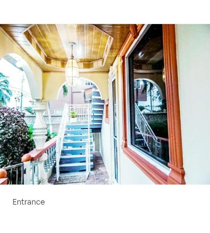 an entrance to a house with a staircase and a window at Essentials Suite in Bon Accord