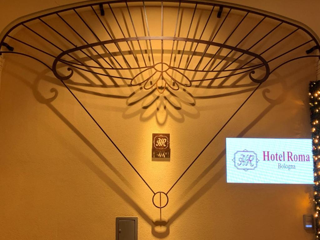 a museum exhibit with a large metal fan on the wall at Hotel Roma in Bologna