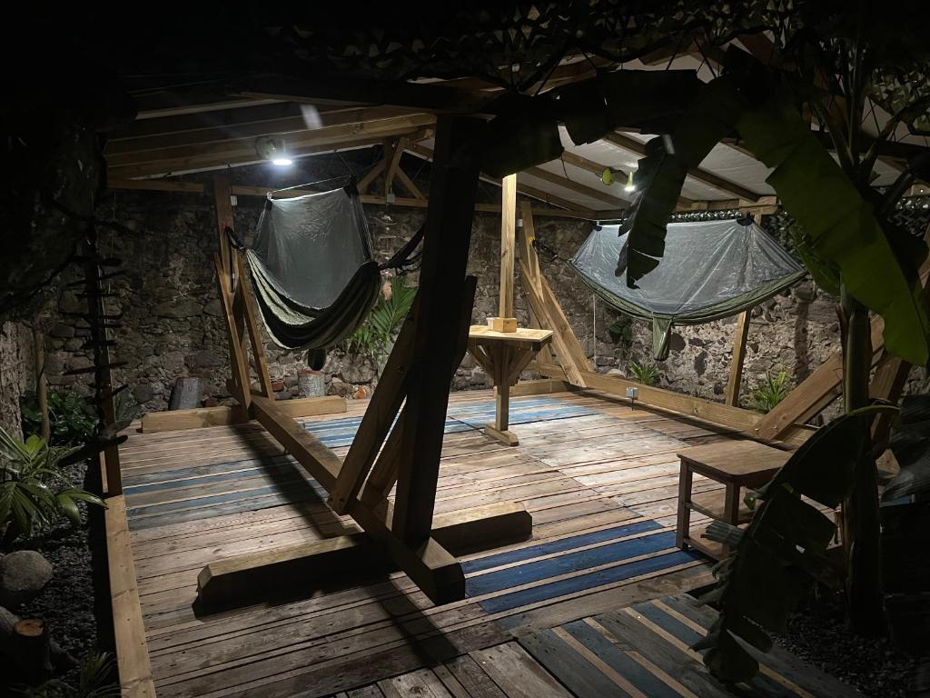 a wooden deck with a hammock in a tent at Les hamacs aux Saintes in Terre-de-Haut