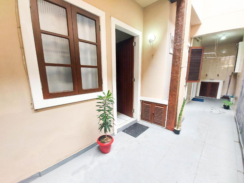 a house with a potted plant in front of a door at Central Flat 2 quartos - Centro de Búzios in Búzios