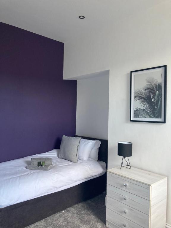 a bedroom with a bed with a nightstand and a picture at Alexandra House in Goole