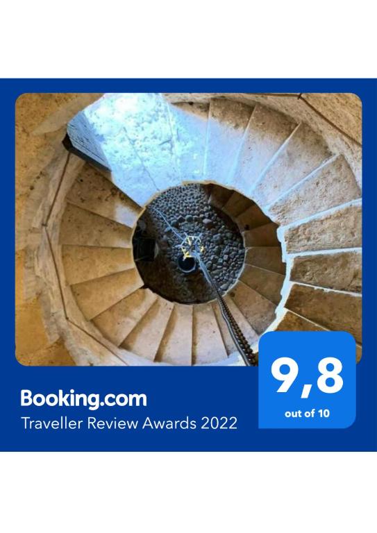 a view of a spiral stairway with a sign that says travel review awards at Molí D,en Barret in Santa Margalida