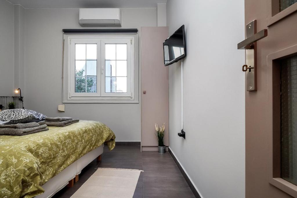 A bed or beds in a room at New Apartment in the Heart of Plaka