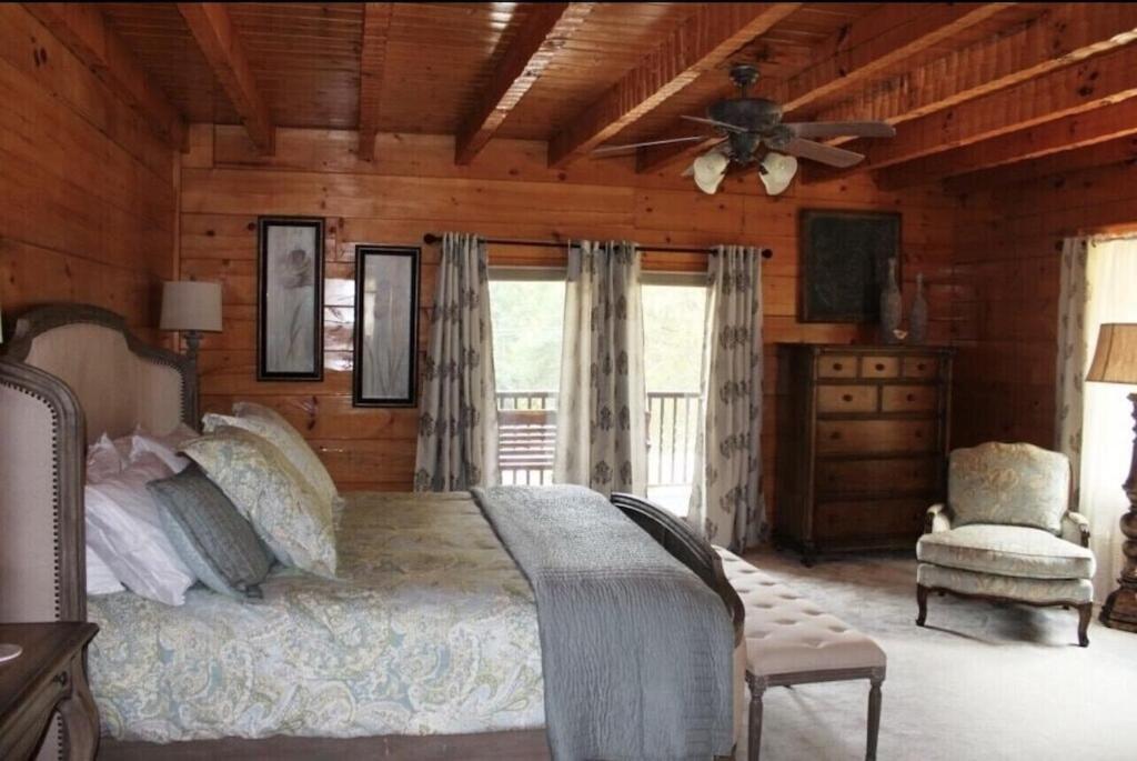 a bedroom with a bed and a ceiling fan at A River Runs Through It in Sevierville