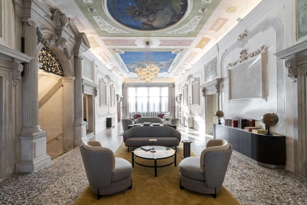 a lobby with chairs and a table and a ceiling at Radisson Collection Hotel, Palazzo Nani Venice in Venice