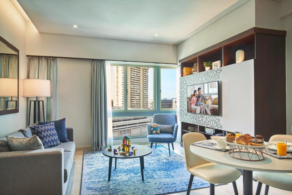 a living room with a couch and a table at Somerset Bencoolen Singapore in Singapore