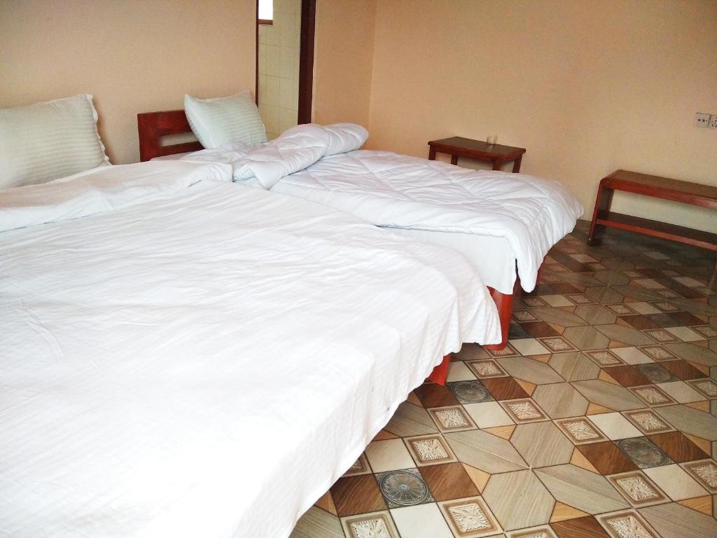Rúm í herbergi á Paramount guest house