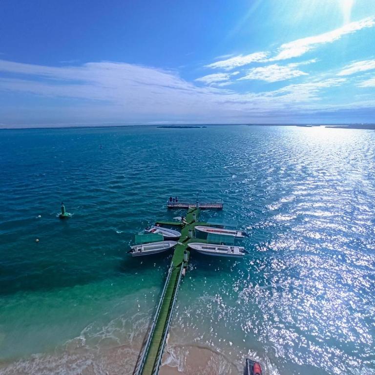 a group of boats sitting in the water at Flamingo Beach Hotel in Umm Al Quwain