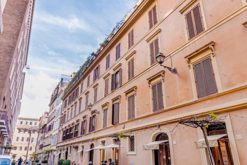 a large building with many windows on a street at Frezza's Holidays in Rome