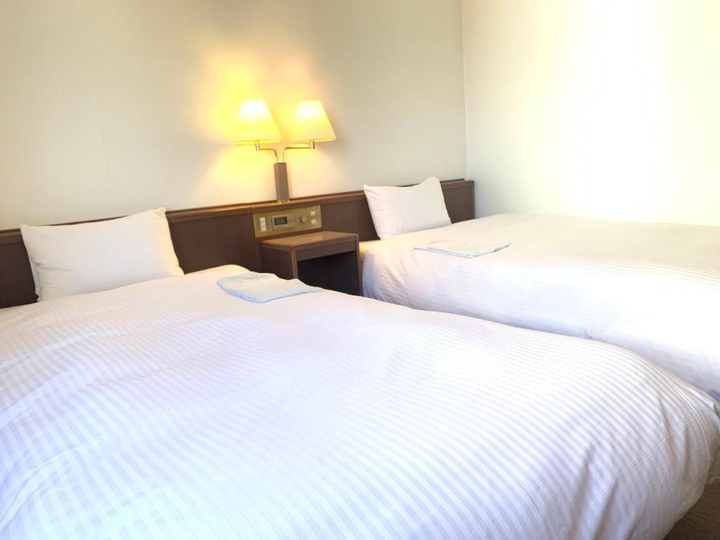 Postel nebo postele na pokoji v ubytování Hotel Ascent Hamamatsu