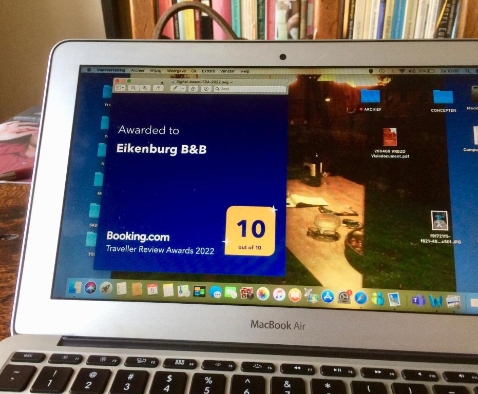 Una computadora portátil abierta sobre un escritorio en Eikenburg B&B, en Eindhoven