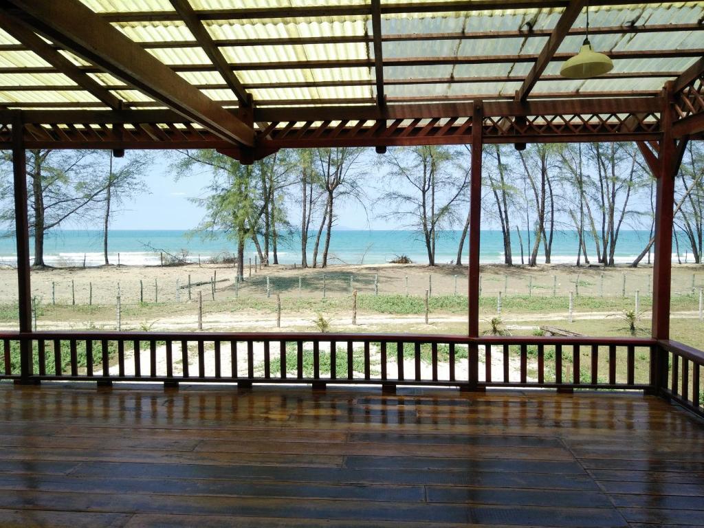 a porch with a view of the beach at thesanctuary@telagapapan in Kampung Hulu Caluk