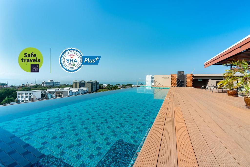 a swimming pool on the roof of a building at LawinTa Hotel Pattaya in Jomtien Beach