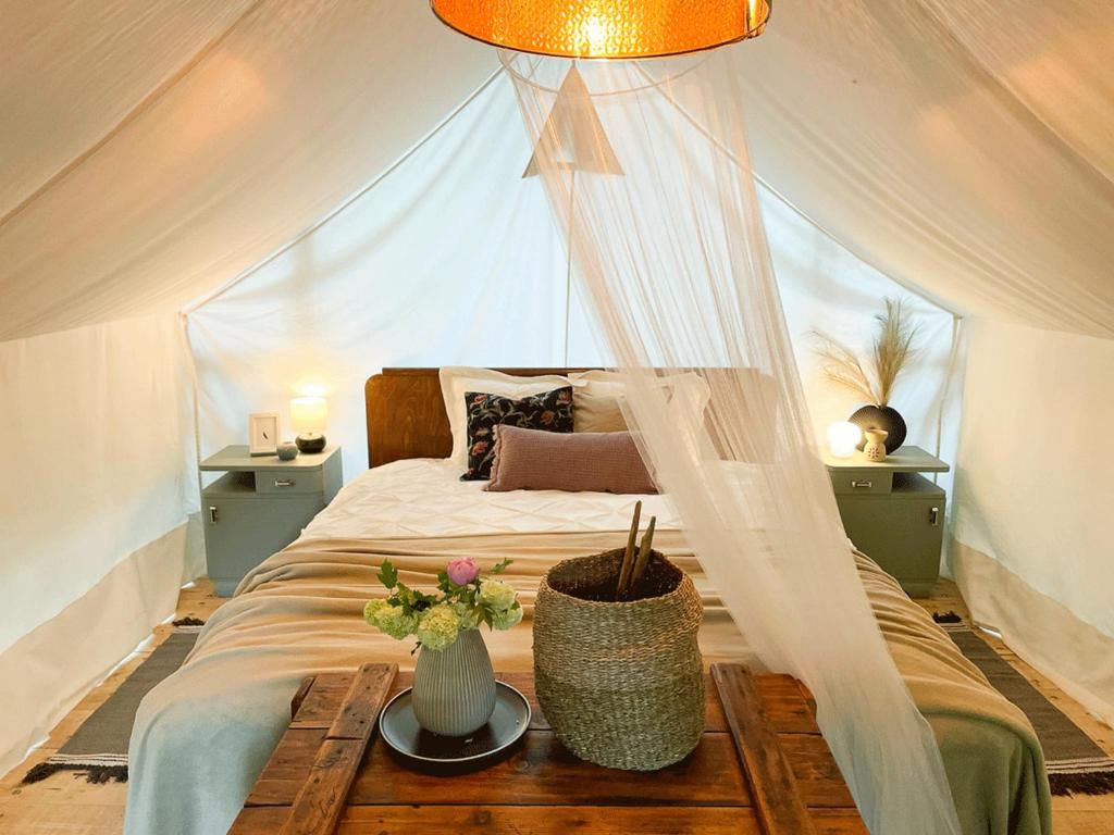 - une chambre avec un lit dans une tente dans l'établissement Vintage tent at the Lovsin Estate, à Metlika