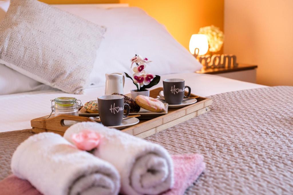 a tray with towels and coffee cups on a bed at Villa Ankora in Supetar