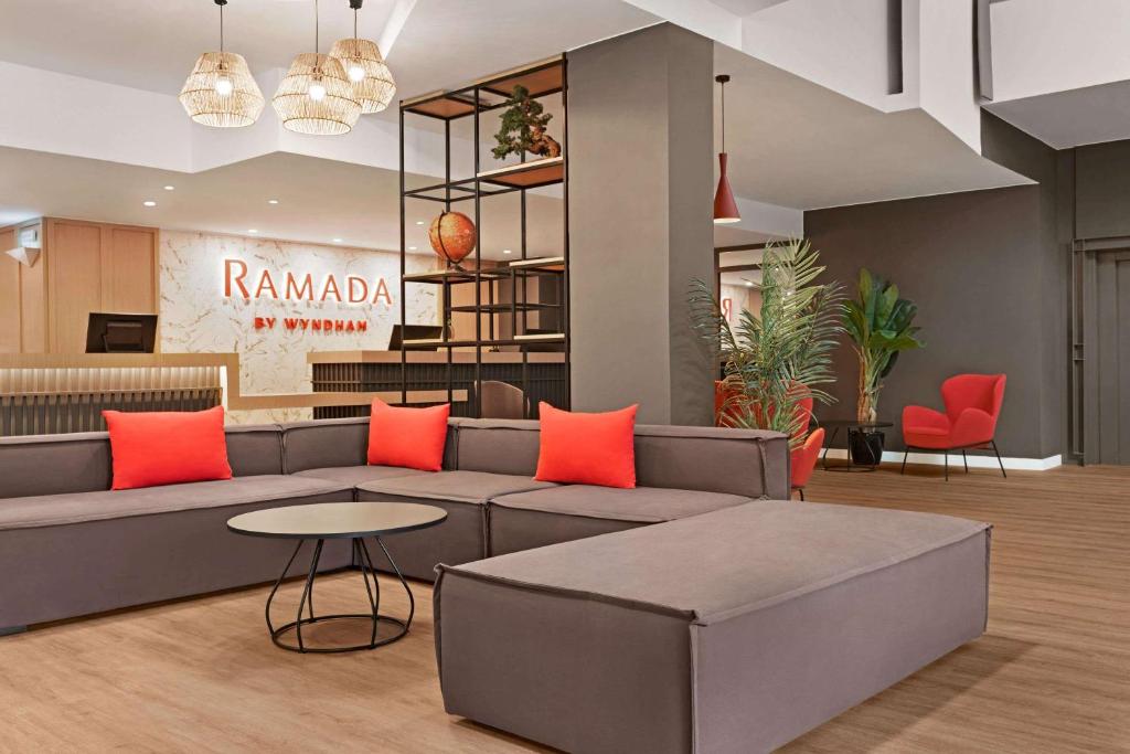 a living room with a couch and a table at Ramada by Wyndham Valencia Almussafes in Almussafes