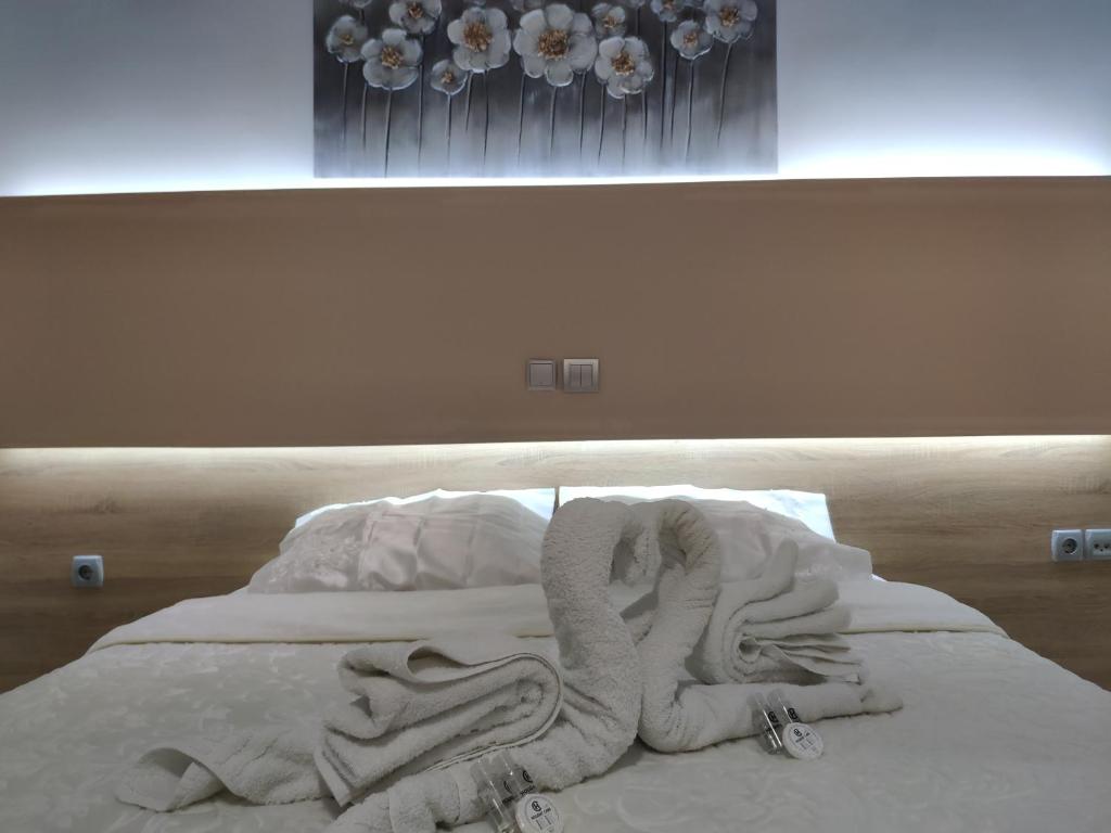 un letto con un mucchio di coperte sopra di Marie Hotel a Città di Kos