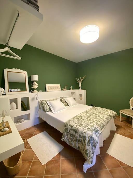 une chambre avec un lit et un mur végétal dans l'établissement Casa vacanza al Duomo: Cefalù, à Cefalù