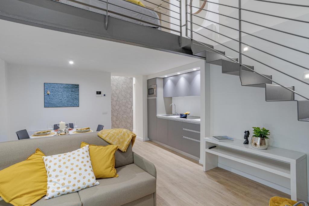 uma sala de estar com um sofá e uma escada em Suite Roma - by MyHomeInComo em Como