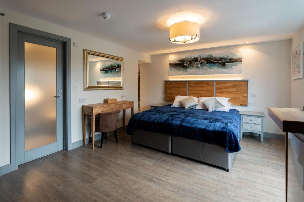 a bedroom with a bed and a desk and a table at Magnolia House, Rye in Rye