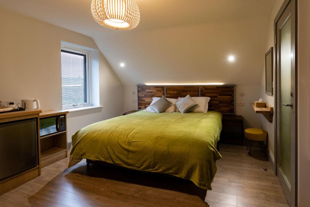 a bedroom with a large bed with a yellow blanket at Magnolia House, Rye in Rye