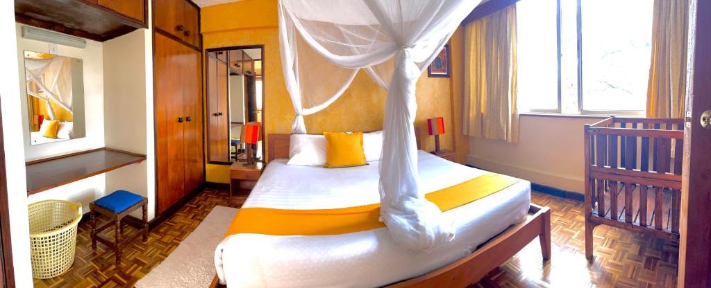 Postel nebo postele na pokoji v ubytování Kenya Comfort Suites