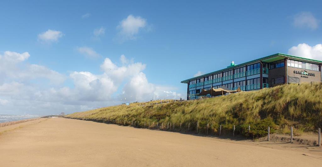 a building on top of a hill next to a beach at Beachhouse Hotel in Zandvoort