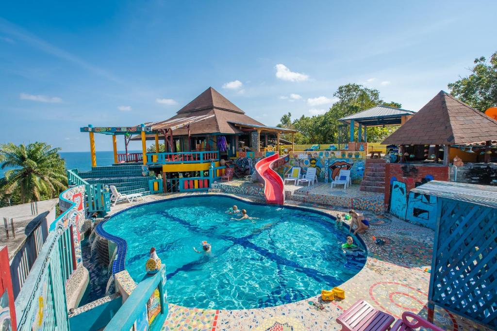 a large pool with a water park with people in it at Varinda Resort in Lamai