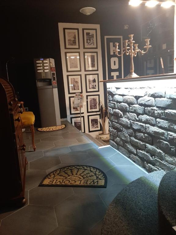 a room with a stone wall and a fireplace at Green Garden Zvonex Tuzla in Tuzla