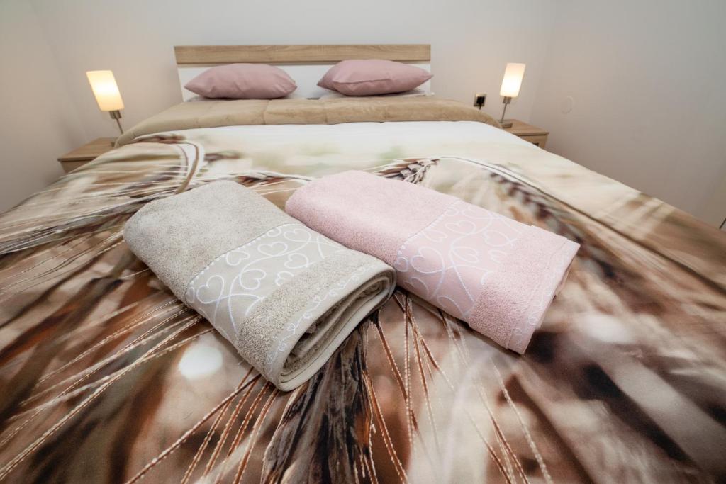 um quarto com uma cama com duas almofadas em Kuća za odmor Anima em Ravna Gora