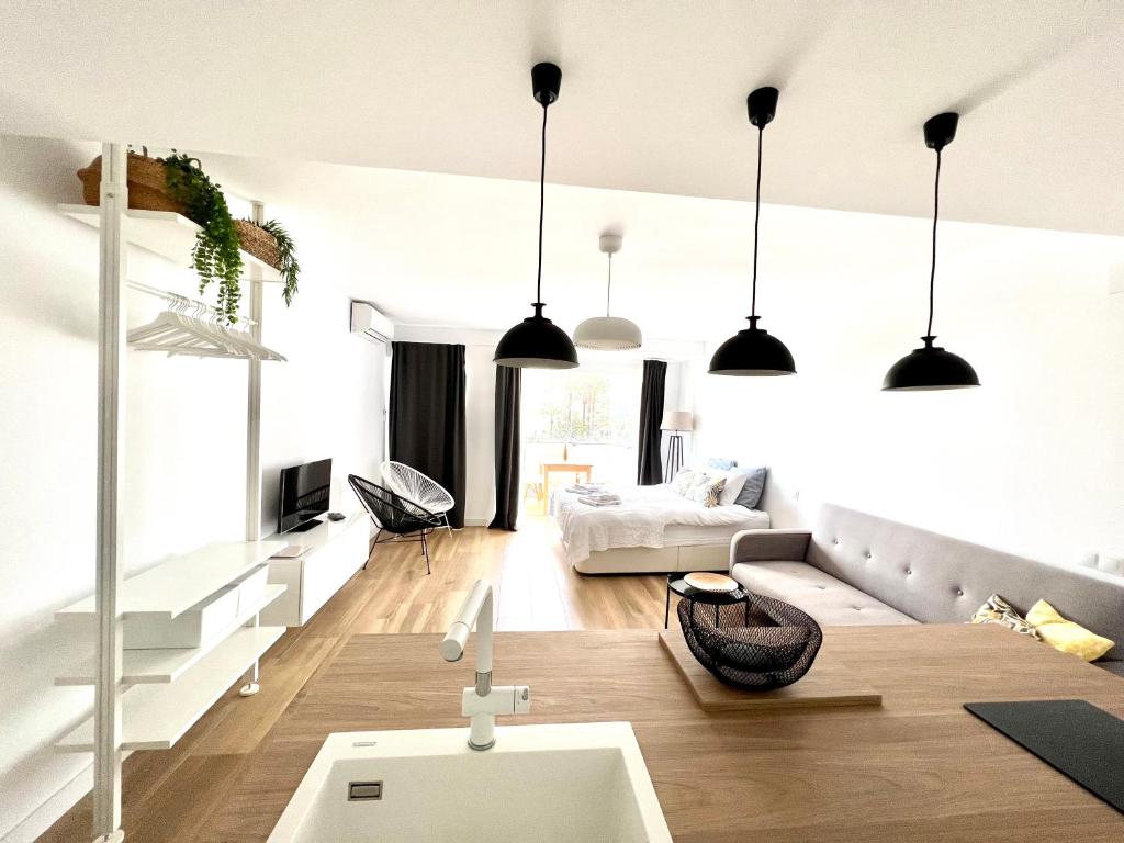 a living room with pendant lights and a couch at Holiday Studio by Meatina in Torremolinos