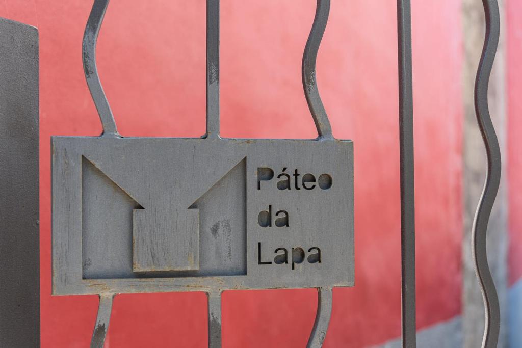 a metal sign on a gate with the words platela da la laiane at GuestReady - The New Pateo da Lapa - Casa 3 in Porto