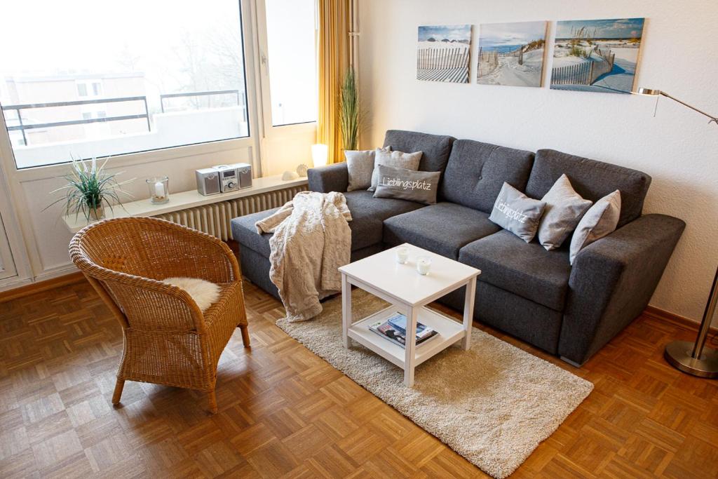 a living room with a couch and a table at Oland Whg 17 Wellenflüstern in Wyk auf Föhr
