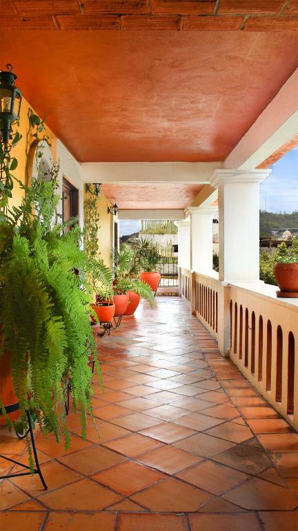 a porch of a house with potted plants at Parador del Dominico in Oaxaca City