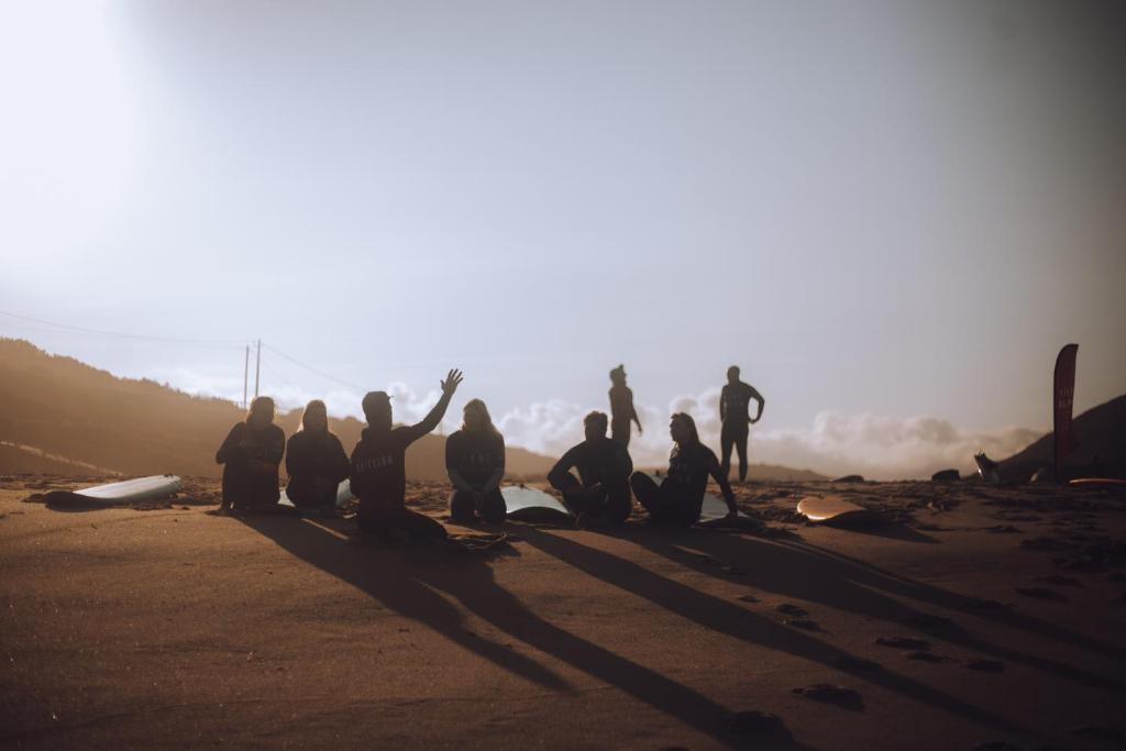 a group of people sitting on the beach at João Jungle in Açafora