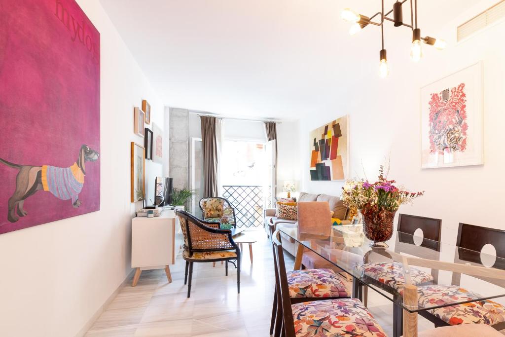 a living room with a table and chairs and a dining room at Apartamento Vicky Victoria in Málaga