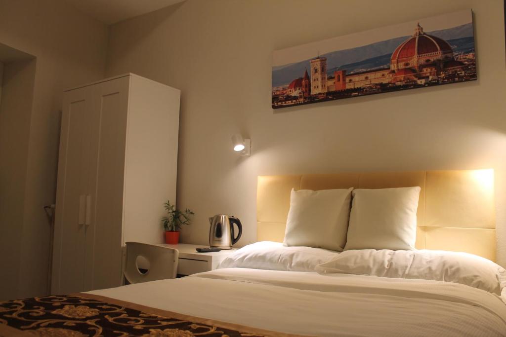 Postel nebo postele na pokoji v ubytování Hotel 900 Toscana