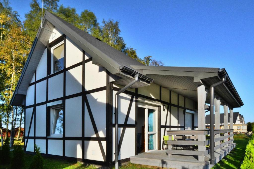 a small house with a pitched roof at Holiday bungalow for 4 people Jaroslawiec in Jarosławiec