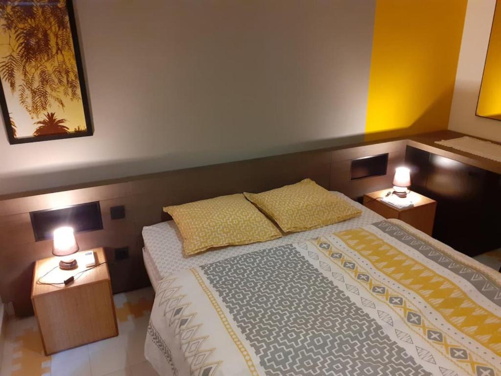 Postel nebo postele na pokoji v ubytování Le Studio les Tropiques au Village MANGANAO