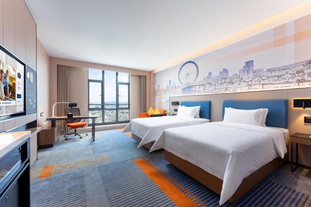 Postel nebo postele na pokoji v ubytování Hampton by Hilton Guangzhou Jinshazhou