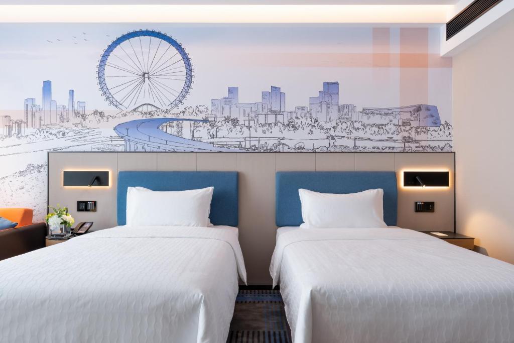 Postel nebo postele na pokoji v ubytování Hampton by Hilton Guangzhou Jinshazhou