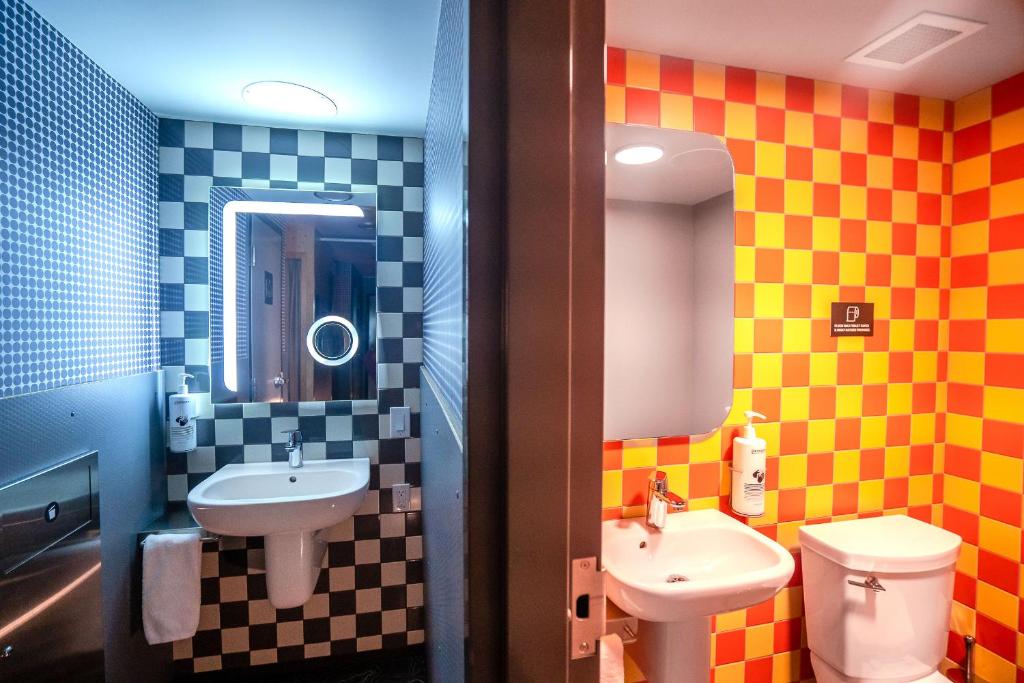 a bathroom with a sink and a toilet at Pangea Pod Hotel in Whistler