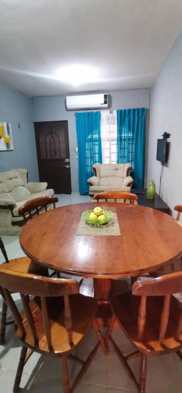 a living room with a wooden table and chairs at Casa Huasteca Potosina in Ciudad Valles